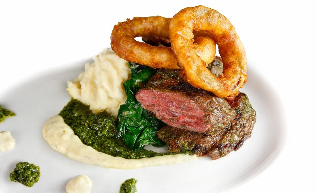 skirt steak with chimichurri sauce, mashed potatoes and buttermilk onion rings